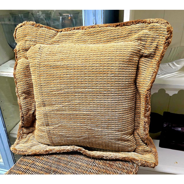 Very pretty throw pillow. on the front and a very A very soft short fringed, tan and green striped back. In the front...