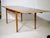 Extendable Danish teak dining table from the 1960s. A classic 1960s design with a rectangular tabletop, gently rounded...