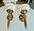 Pair French 1950's brass wall sconces of hands holding a torch with alabaster shade, attributed to John Devoluy. The hand...