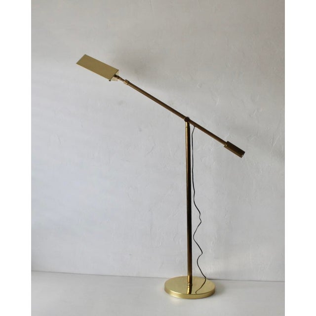 Vintage brass articulated pharmacy floor lamp, in the style of Casella Lighting. The classic shade is fully adjustable and...