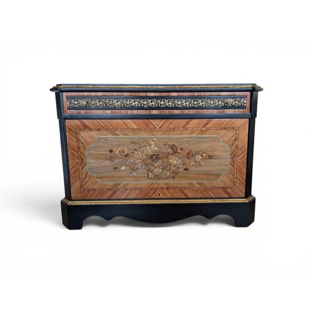 The structure is characterized by a refined chromatic interplay: the sides, top, and contoured base are finished in an...