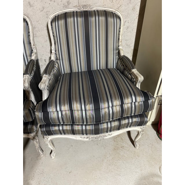 Beautiful Pair of Louis XV style French Bergere chairs in Antique White finish. Also included: 2 unused identical extra...