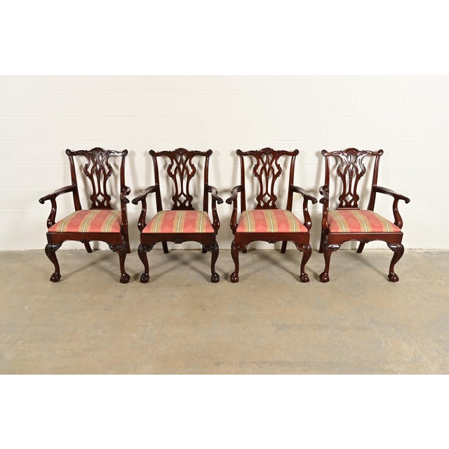 An outstanding set of four Chippendale or Georgian style dining arm chairs By Kindel Furniture USA, Circa 1980s Carved...