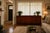 Elegant wood sideboard has a dark brown finish. This Gina B. Furniture piece features Asian-inspired circular metal...