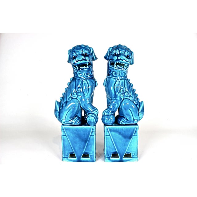 Lovely pair of 1960's turquoise glaze ceramic foo dogs. Each measures 12.5" tall by 4" wide and 3" deep. Both are in...
