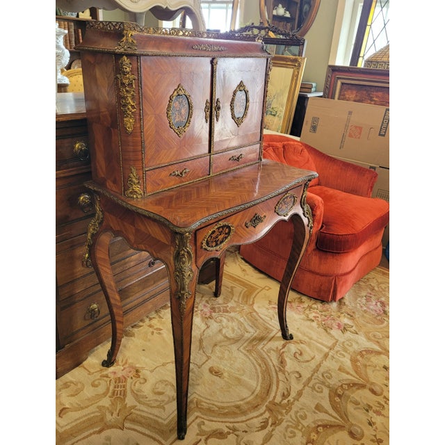 Beautiful antique French writing desk. Features inlaid satinwood matched grain veneer, inlaid medalions on the drawers and...