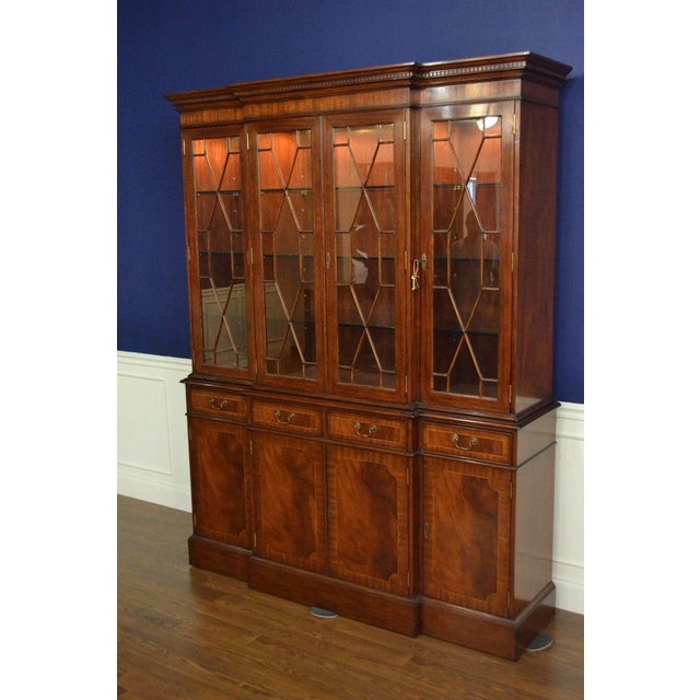 This is a Traditional Georgian Style Breakfront China Cabinet/Bookcase by Leighton Hall. It features four bottom doors and...