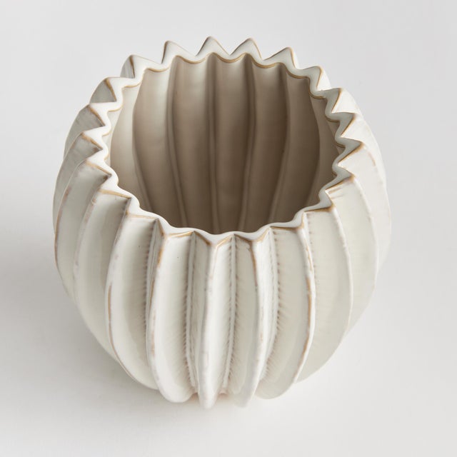With a rounded form, deep ribbing and thickly applied glaze, this natureinspired pot is a work of art. The handfinished...