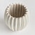 With a rounded form, deep ribbing and thickly applied glaze, this natureinspired pot is a work of art. The handfinished...