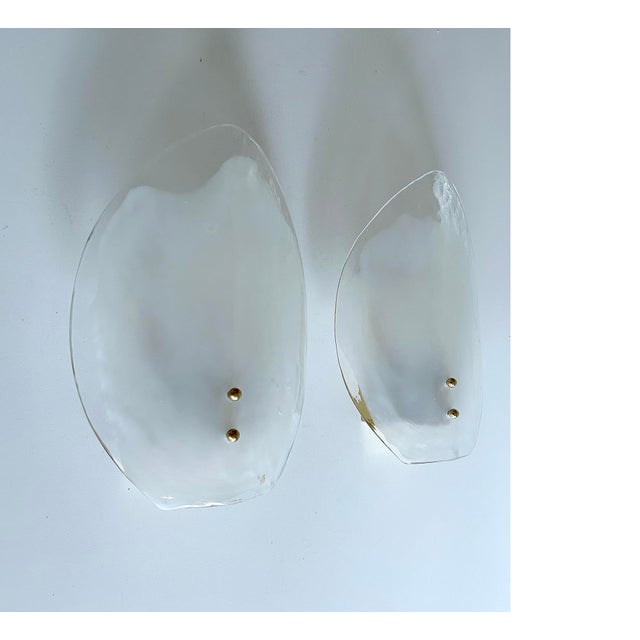 Pair of Vintage sconces with large leaf shaped Murano glass shades, partly milk mounted on a rectangular brass base Very...