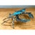 This vintage metal crab figure is a sculptural study in oxidized color, modeled with the lifelike detail of a blue crab....