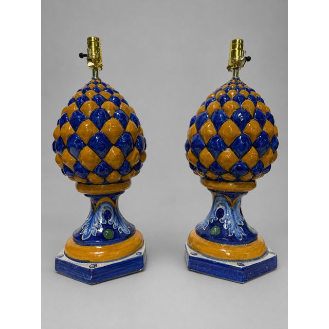 A visually commanding pair of sculptural table lamps, each modeled as an exuberant artichoke raised upon an architectonic...