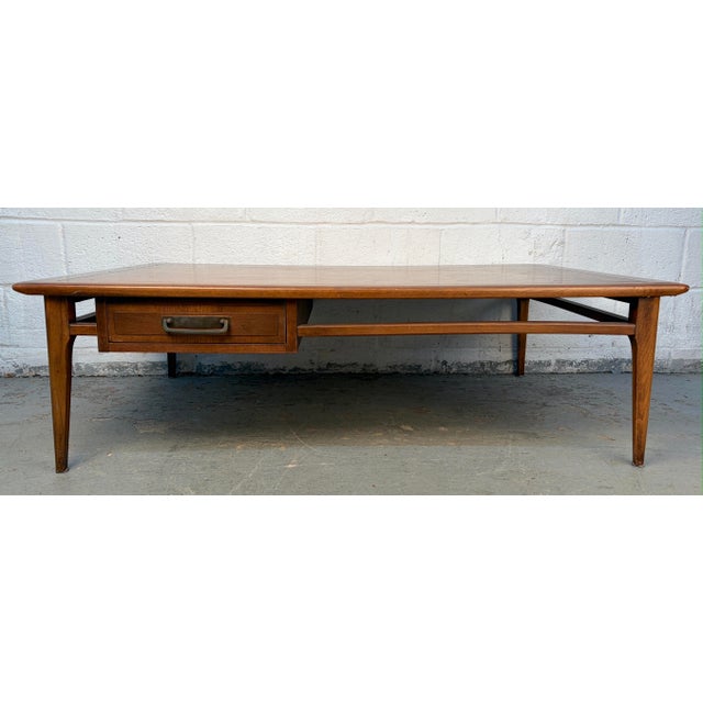 Vintage Mid-Century Walnut Coffee Table by Lane Furniture showcasing classic mid-century design with rich walnut grain and...