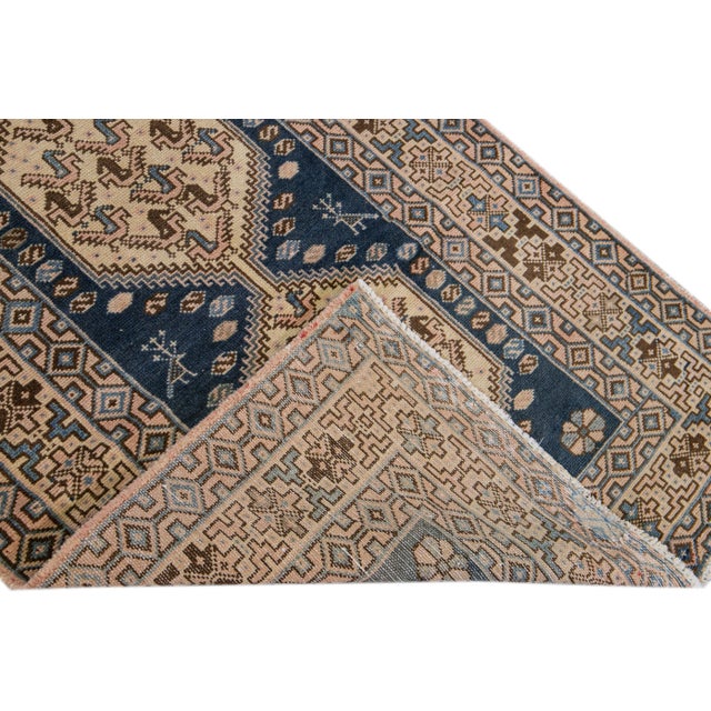 Beautiful Vintage Geometric hand-knotted wool runner with a blue field. This runner has brown and tan accents all-over a...