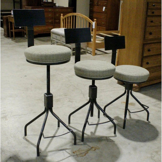 Featuring an industrial-inspired design, this set is constructed with black steel frames, tripod-style bases, and...