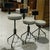 Featuring an industrial-inspired design, this set is constructed with black steel frames, tripod-style bases, and...