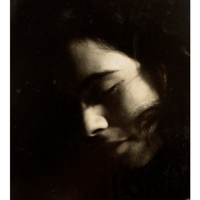 Photo portrait of a woman by Arnulf Rabl (German-American, 1942-2016). In this soft portrait, the woman has her head...