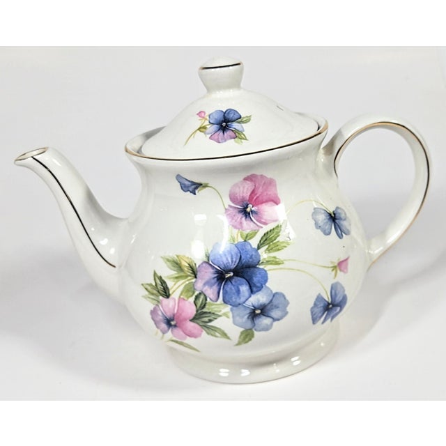 Multi-colored pastel pansies are strewn artistically over this English Sadler teapot. The style is just shy of...