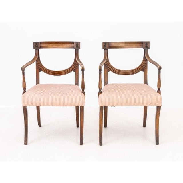 Pair of Regency Style Mahogany Arm Chairs, each with fluted back splat and arms with rosettes, red and white striped...