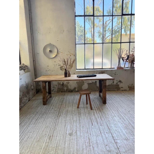 Antique pine work table from the 1950s. We love the overall patina of the piece, its pine top resting on four square legs...