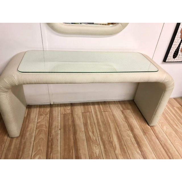 Vintage Karl Springer Style upholstered waterfall console with matching upholstered mirror with nice radius. Console comes...