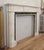 Regency style white statuary marble mantel with light gray veining and emerald green marble inlay framing the firebox. The...