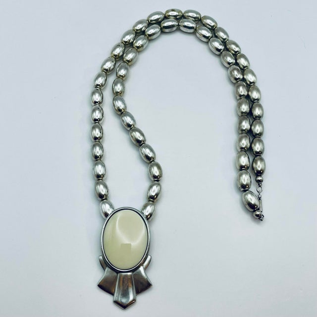 Ben-Amun (Signed) c. 1980s Runway Era long silver tone beaded pendant necklace featuring sculptural silver tone beads and...