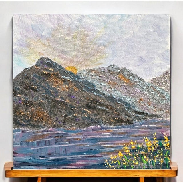 Bring vibrant hand-painted beauty to your space with this textured acrylic landscape of a sunrise, mountains, and...