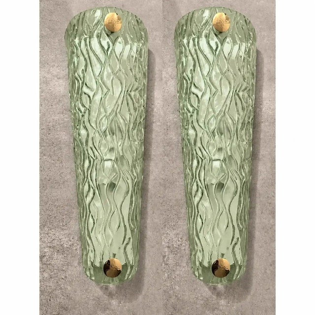 Impressive wall sconce made in clear graniglia of murano glass. made with a traditional murano glass slab processing...