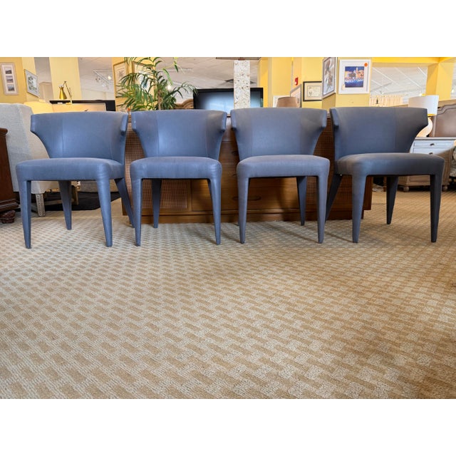 Elevate your dining space with this striking set of four "Lapel" dining armchairs from the ultra-premium Baker Luxe...