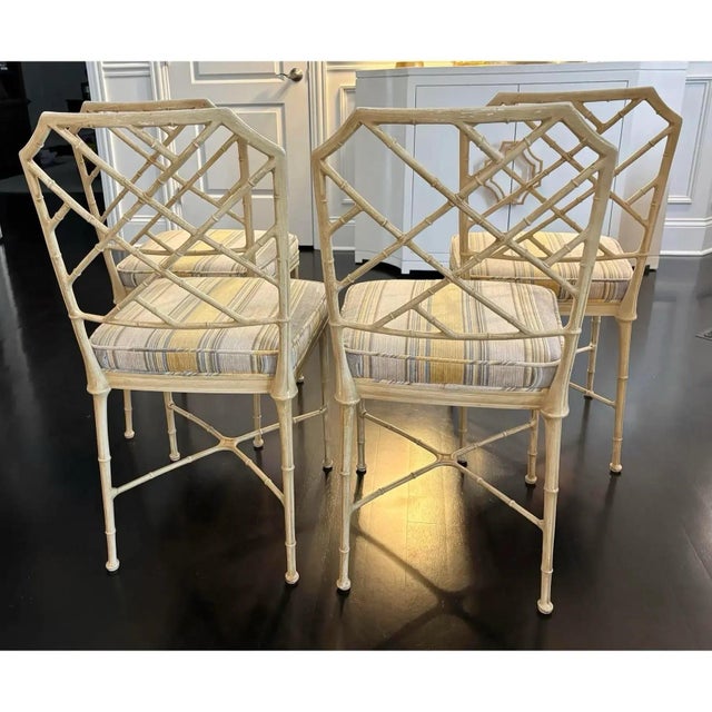 Offered is a hard to find vintage set of metal chinoiserie style metal dining chairs attributed to Brown Jordan. This set...
