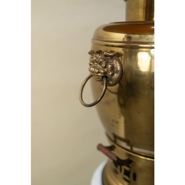 An elegant vintage brass samovar-style table lamp with a pleated linen shade. The base, inspired by antique tea urns,...