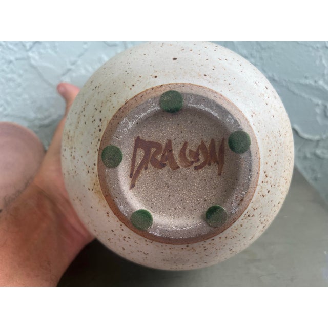 This is a beautifully handcrafted studio pottery lidded jar signed “DRAGM” on the base, featuring a highly sculptural...