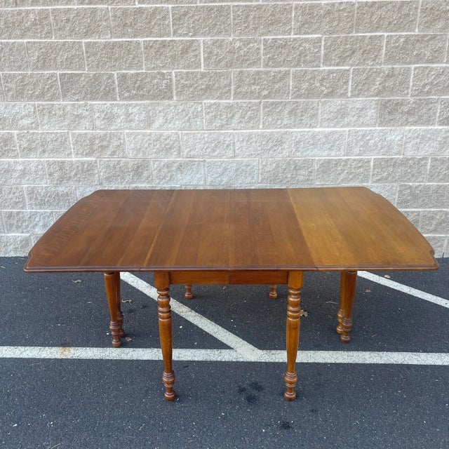 A late 20th century Thomasville Furniture Bay Colony collection Traditional style solid cherry drop leaf gate leg...