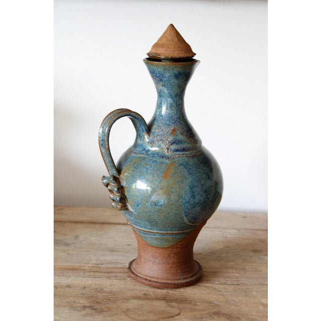 Mid-Century modern art pottery decanter and set of eight goblets. This set is a gorgeous addition to have displayed on a...