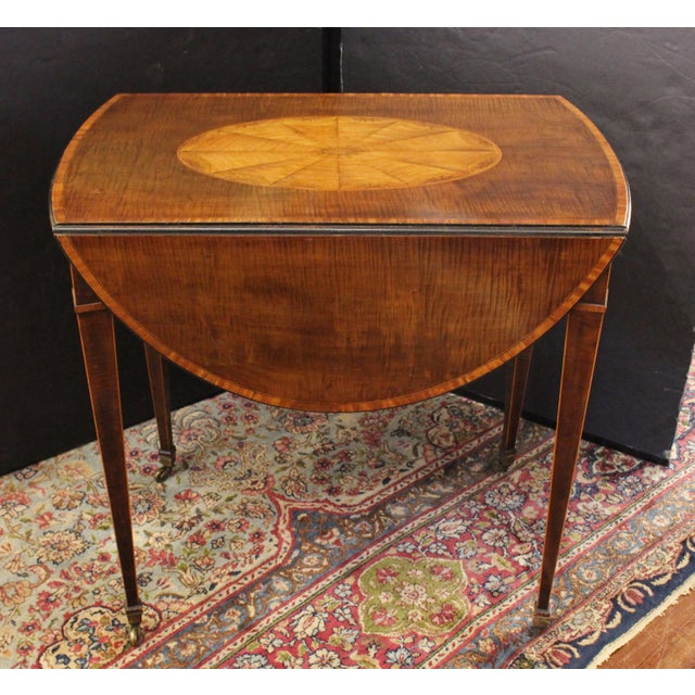 Circa 1790 Sheraton taste oval pembroke table by George Simson, London. A significant labeled piece with molded top...