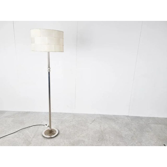 Unique chromed metal floor lamp. It has a nice sculpted brutalist style base and also features two brutalist design...