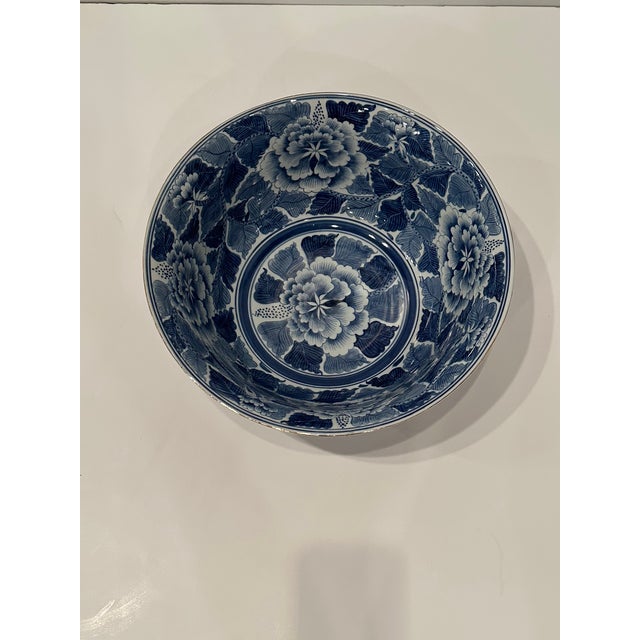 Beautiful antique Chinese porcelain bowl having expressive blue and white hand painted floral decoration and brass accents...