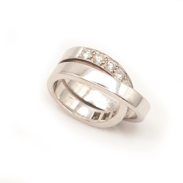 Authentic Cartier Nouvelle Vogue Ring Resembles a twisted ribbon with 11 diamonds approximate 1.00 carat E-F color VS...
