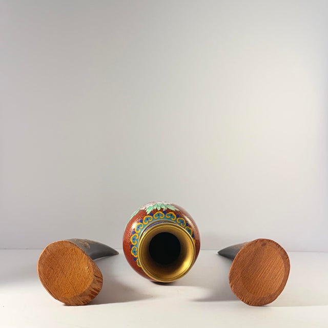 This vibrant cloisonné vase displays blooming peonies and cherry blossoms on a deep red background with traditional cloud...