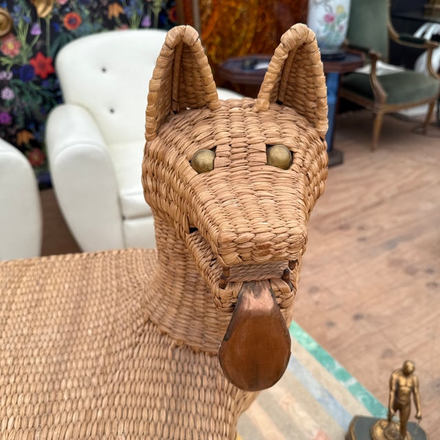 A vintage original rattan coyote bench by Mario Lopez Torres. The coyote has a copper tongue and the original brass...