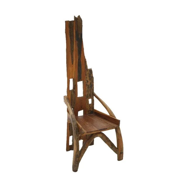 - Mid-20th century sculptural chair - Composed of remains of ancient farming implements - Handmade of olive wood and...