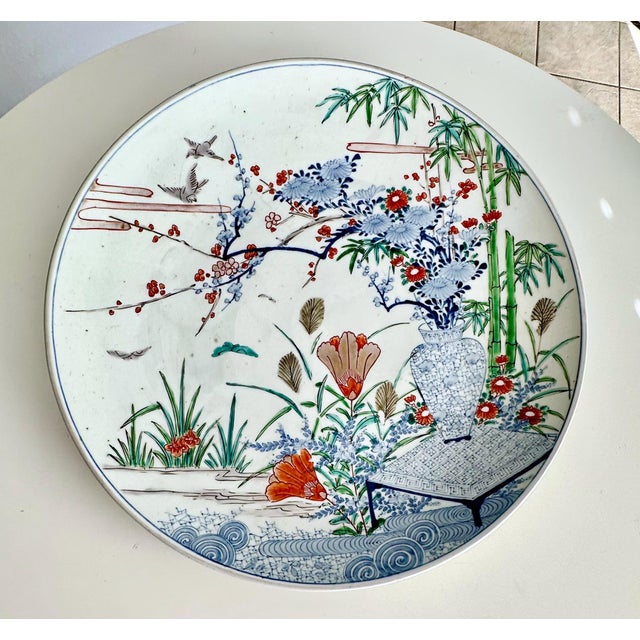 Edo period hand painted Japanese Arita ware porcelain dish or charger, produced in the Kakiemon style. The dish features a...