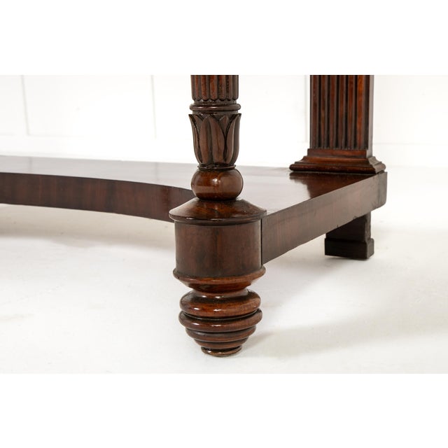 A pair of 19th century italian mahogany console tables with marble tops. these stylish console tables are examples of...