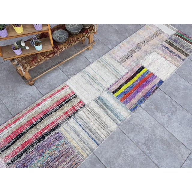 This is a vintage Turkish Oushak rug from the Mid 20th Century. The piece was hand-knotted.