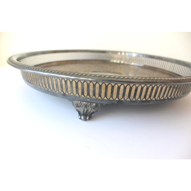 15.25” vintage round silver plated footed gallery tray with rope detail around the edge and embossed detail on the base....