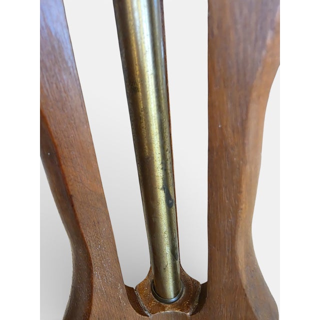 Beautiful pair of vintage table lamps featuring sculptural carved wood bases and softly curved linen shades. Sold as a...