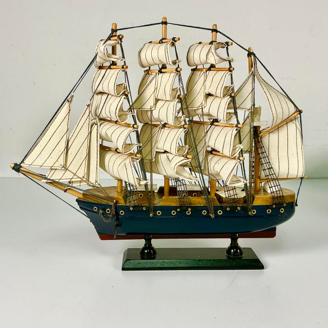 Vintage Home is pleased to offer this wood Tall Four Mast wood Ship Model from the Mid-Century. It features layers of...