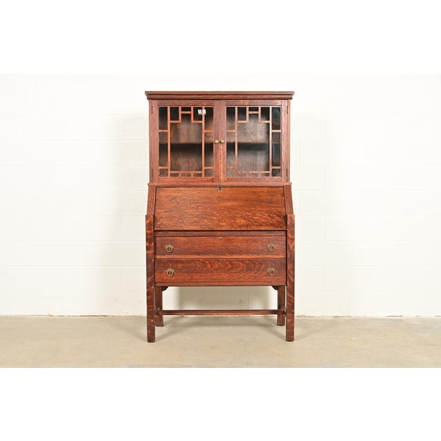 A gorgeous antique Mission or Arts & Crafts period drop front secretary desk or writing desk with bookcase hutch top In...