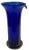 This striking 11½-inch tall vase captures the expressive freedom of hand-blown glass, rendered in a lustrous oceanic blue...